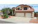 Charming two-story home with a red tile roof, a two-car garage, and desert landscaping at 14009 N 30Th St, Phoenix, AZ 85032