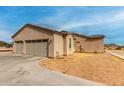 Spacious three-car garage, part of the house's exterior, featuring neutral colors that blend with the desert environment at 1444 W Gail Rd, San Tan Valley, AZ 85144