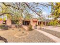 View of the home's facade and drought-resistant yard, showcasing the sidewalk and desert landscape at 1822 N 16Th Ave, Phoenix, AZ 85007