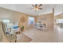 Bright dining area with tile flooring, a cozy armchair, and a beautifully set table near a window at 2019 E Wahalla Ln, Phoenix, AZ 85024