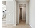 Bright hallway featuring tile floors, neutral paint, and a glimpse of the staircase at 21208 N 58Th St, Phoenix, AZ 85054