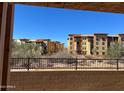 Scenic view from the home overlooking neighboring tan apartment buildings and desert landscaping at 21208 N 58Th St, Phoenix, AZ 85054