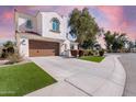 Inviting two-story home boasting a tile roof, lush lawn, desert landscaping, and an attached two-car garage at 2300 W Sunrise Pl, Chandler, AZ 85248