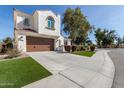 Spacious home with a two-car garage, lush landscaping, and a well-maintained lawn at 2300 W Sunrise Pl, Chandler, AZ 85248