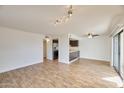 Open-concept living room adjacent to kitchen, featuring tile floors and lots of natural light at 2959 N 68Th Pl # 112, Scottsdale, AZ 85251