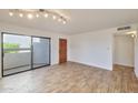 Living room with neutral color palette offering tile floors, access to front door and covered patio at 2959 N 68Th Pl # 112, Scottsdale, AZ 85251