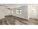 Bright, spacious living room with modern light fixtures and stylish gray wood flooring at 3322 E Willetta St, Phoenix, AZ 85008