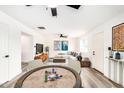 Open-concept living space featuring a poker table, living room, modern furniture, and neutral decor at 3322 E Willetta St, Phoenix, AZ 85008