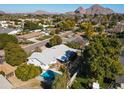 Aerial view of home in a neighborhood setting, complete with a private pool and mountain views at 3511 E Elm St, Phoenix, AZ 85018