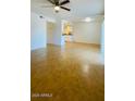 Bright living room featuring tile flooring and a ceiling fan at 3810 N Maryvale Pkwy # 1068, Phoenix, AZ 85031