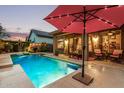 Relaxing backyard pool area with a large patio, perfect for outdoor entertaining with an umbrella and furniture at 4216 E Desert Marigold Dr, Cave Creek, AZ 85331