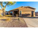 Inviting home with a well-maintained front yard, desert landscaping, and an attached two-car garage at 4267 S Strong Box Rd, Gold Canyon, AZ 85118