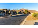 Scenic street view showcasing well-maintained homes and desert landscape with a beautiful mountain backdrop at 4267 S Strong Box Rd, Gold Canyon, AZ 85118