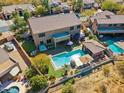 Aerial view showcasing a backyard oasis with pool, spa, outdoor kitchen, and a putting green at 4502 E Night Owl Ln, Cave Creek, AZ 85331