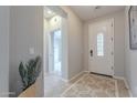 Bright foyer with tile flooring, neutral paint, decorative rug, and a glimpse into adjacent rooms at 518 E Laddoos Ave, Queen Creek, AZ 85140