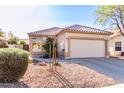 Charming single-Gathering home features a neutral-colored exterior and a well-maintained front yard with desert landscaping at 653 S Catalina St, Gilbert, AZ 85233