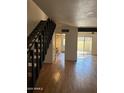 Spacious living area with hardwood floors and staircase at 6542 N 7Th Ave # 30, Phoenix, AZ 85013