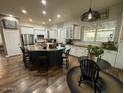 An open kitchen featuring a large island, modern appliances, and breakfast nook with great lighting at 6881 W Greenbriar Dr, Glendale, AZ 85308