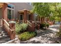 Inviting exterior view of townhomes with charming brick accents, private entrances and mature landscaping at 710 S Beck Ave, Tempe, AZ 85281