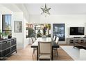 Dining room featuring hardwood floors, modern decor, and an oversized window at 9246 N 108Th St, Scottsdale, AZ 85259