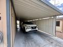 Attached carport view featuring ample parking space and a modern car at 9302 E Broadway Rd # 64, Mesa, AZ 85208