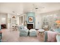 Inviting living room with a fireplace, bright windows with shutters, and elegant furnishings at 9550 E Thunderbird Rd # 259, Scottsdale, AZ 85260