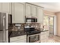 Modern kitchen with stainless steel appliances, including a microwave and electric stove at 1295 N Ash St # 125, Gilbert, AZ 85233