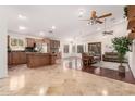 Open-concept living space with tile flooring, ceiling fans, modern sofas, and a kitchen island at 1409 W Maria Ln, Tempe, AZ 85284