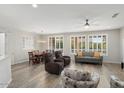 Bright living room with neutral paint, wood floors and large windows at 15039 W Rounders Dr, Surprise, AZ 85374