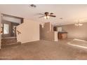 Comfortable carpeted living room with stairs and view into kitchen at 1585 E Jeanne Ln, San Tan Valley, AZ 85140