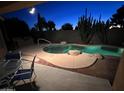 Backyard pool at twilight with desert landscaping, patio and view of the night sky at 20934 N Sweet Dreams Dr, Maricopa, AZ 85138