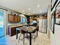 The kitchen area boasts stainless steel appliances, gorgeous counters, tile flooring, and a center island at 21868 S 215Th St, Queen Creek, AZ 85142