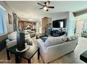 Spacious living room is perfect for Gathering time with a cozy sitting arrangement and ceiling fan at 21868 S 215Th St, Queen Creek, AZ 85142