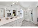 Spacious bathroom with double vanity, modern fixtures, and a glass-enclosed shower at 22714 N Chase Dr, Maricopa, AZ 85138