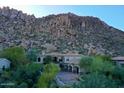 Stunning aerial view of desert home nestled at the base of rocky mountains with lush green landscaping at 25572 N 113Th Way, Scottsdale, AZ 85255