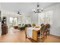 Bright living room with hardwood floors, modern furnishings, and access to a private balcony at 300 N Gila Springs Blvd # 160, Chandler, AZ 85226