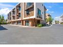 Contemporary townhome showcasing brick accents, private balconies, and multiple garage doors at 3233 N 70Th St # 1006, Scottsdale, AZ 85251