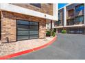 Close-up of a modern garage door with brick surround and paved driveway at 3233 N 70Th St # 1006, Scottsdale, AZ 85251