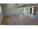 Living room featuring wood floors, with an entry door and view of the enclosed porch at 349 E Thomas Rd # E301, Phoenix, AZ 85012