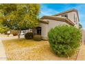 Well maintained home with tidy desert landscaping, mature trees and covered porch at 3663 S Soho Ln, Chandler, AZ 85286