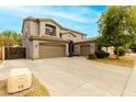Two-story home boasts a three-car garage, neutral stucco and well-maintained front yard at 3663 S Soho Ln, Chandler, AZ 85286