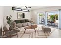 Bright living room with modern furniture, stylish rug, and large sliding doors to the backyard at 3802 E Shaw Butte Dr, Phoenix, AZ 85028