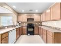 Simple kitchen with light wood cabinets, laminate countertops, and black appliances at 45 S 238Th Dr, Buckeye, AZ 85396