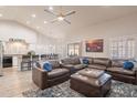 Open-concept living room with vaulted ceilings, a ceiling fan, and comfortable leather seating at 4637 E Fernwood Ct, Cave Creek, AZ 85331