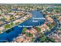 Aerial view of the lakeside community and the property with a community pool at 517 S Marina Dr, Gilbert, AZ 85233