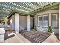 Covered porch with decorative columns and brick accents leading to the front door and window at 5532 W Onyx Ave, Glendale, AZ 85302