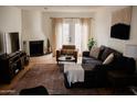 Inviting living room featuring a cozy fireplace and ample natural light at 7023 E 4Th St # 104, Scottsdale, AZ 85251