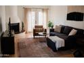 Bright living room with hardwood floors, fireplace and comfortable seating at 7023 E 4Th St # 104, Scottsdale, AZ 85251