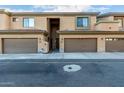View of a well-maintained townhouse complex with private garages and neutral stucco facade at 705 W Queen Creek Rd # 1220, Chandler, AZ 85248