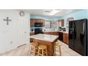 Well-lit kitchen with modern appliances, an island, and wooden cabinetry at 10510 W Louise Dr, Peoria, AZ 85383